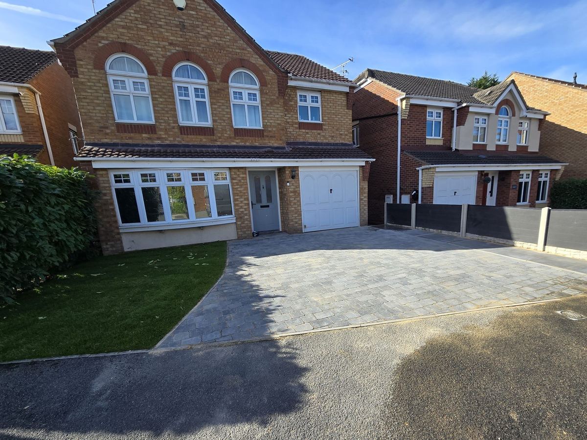 Finished block paved driveway and new lawn in front of a detached house in Castleford